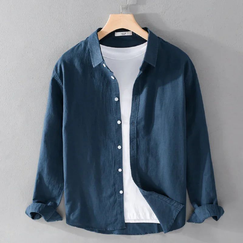 Dark blue casual button-up shirt with rolled sleeves over white t-shirt on wooden hanger