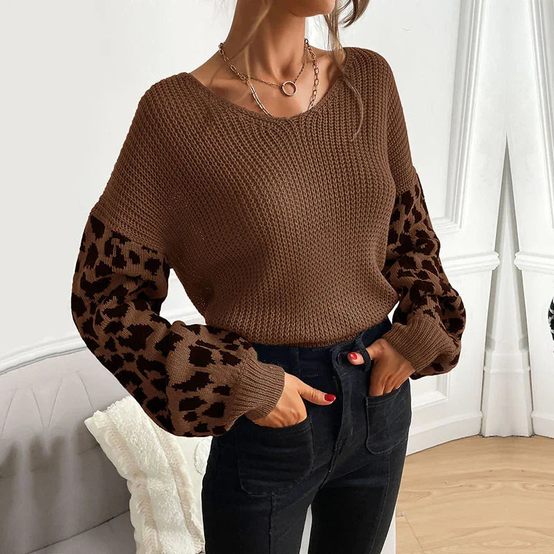 Woman wearing brown knit sweater with leopard print balloon sleeves paired with black high-waist pants