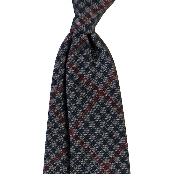 Navy and gray plaid necktie with subtle red stripes on white background