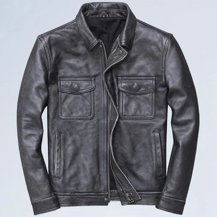 Black leather jacket with two flap chest pockets and front zipper on light background