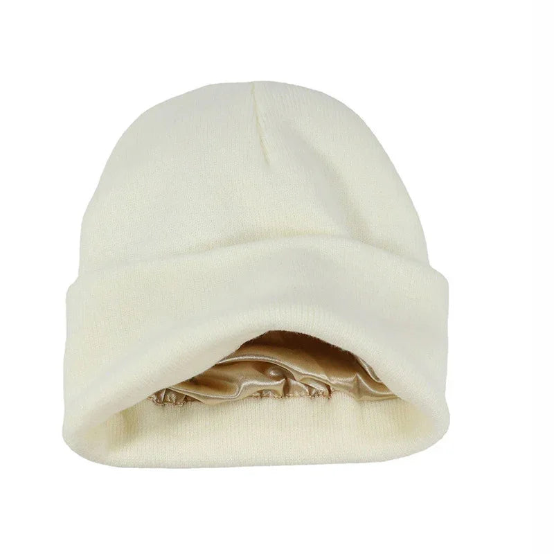 Cream knit winter beanie hat with folded cuff and beige satin lining inside