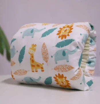 Soft baby blanket with blue elephants, yellow lions, giraffes, and leaf patterns on white background