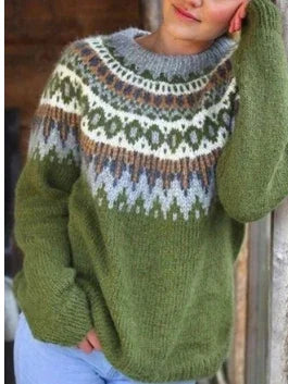 Woman wearing cozy green knit sweater with intricate white, gray, and brown Nordic pattern