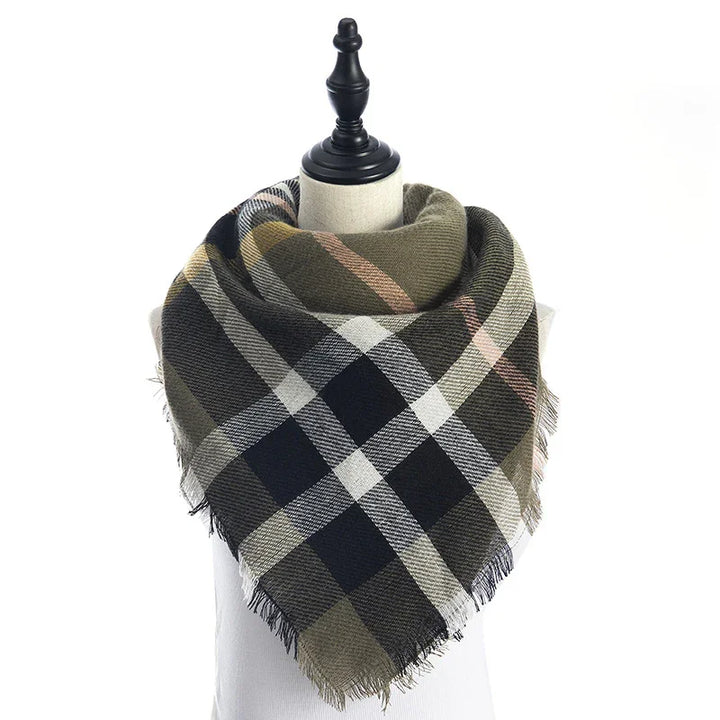 plaid checkered scarf in olive, black, white, and tan on a mannequin with fringe edges