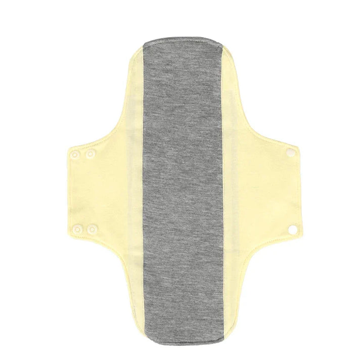 Reusable cloth menstrual pad with yellow wings and gray center panel, snap buttons on sides