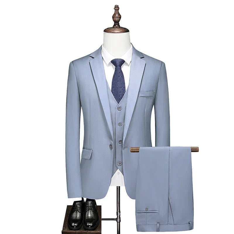 Light blue men's three-piece suit with white shirt, navy tie, black dress shoes on mannequin