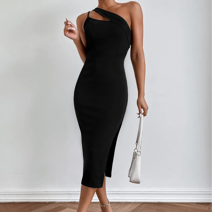 Woman wearing black one-shoulder midi dress with white handbag on wooden floor