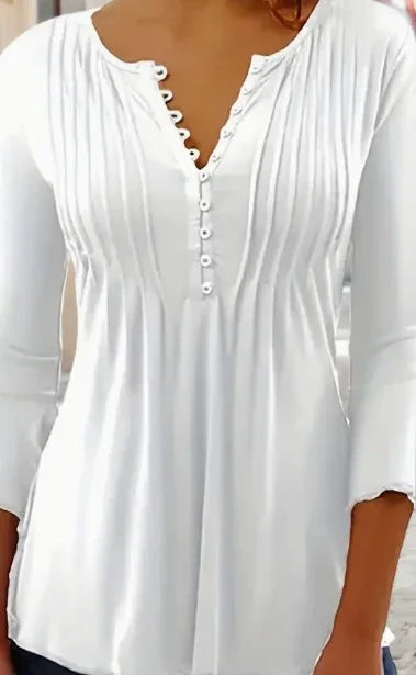 White long-sleeve women's blouse with vertical pleats and button-down front on brown skin model