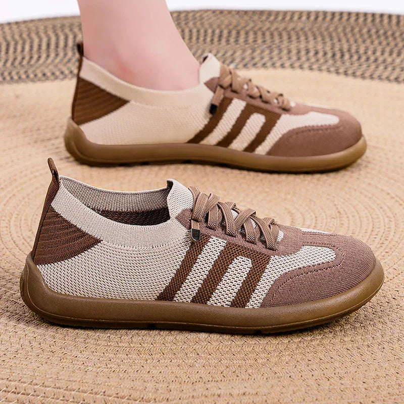Brown and beige knit casual sneakers with laces on woven textured mat background