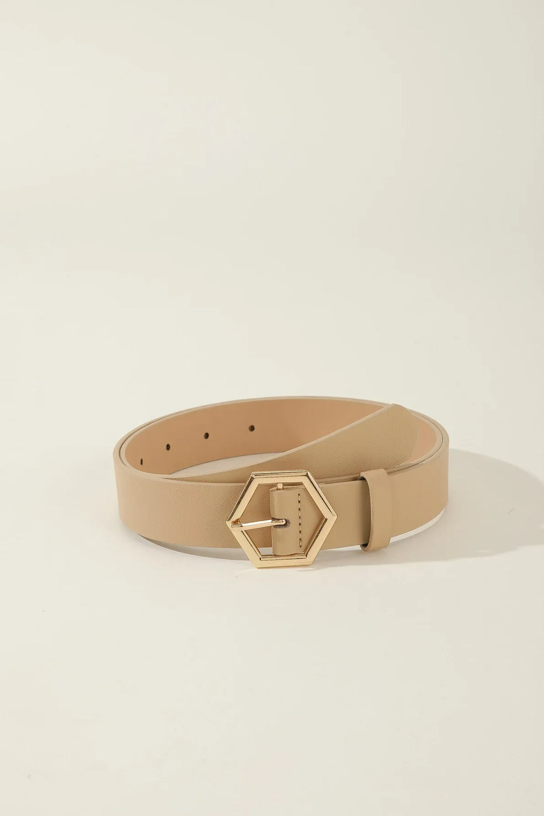 Beige leather belt with gold hexagonal buckle on light background
