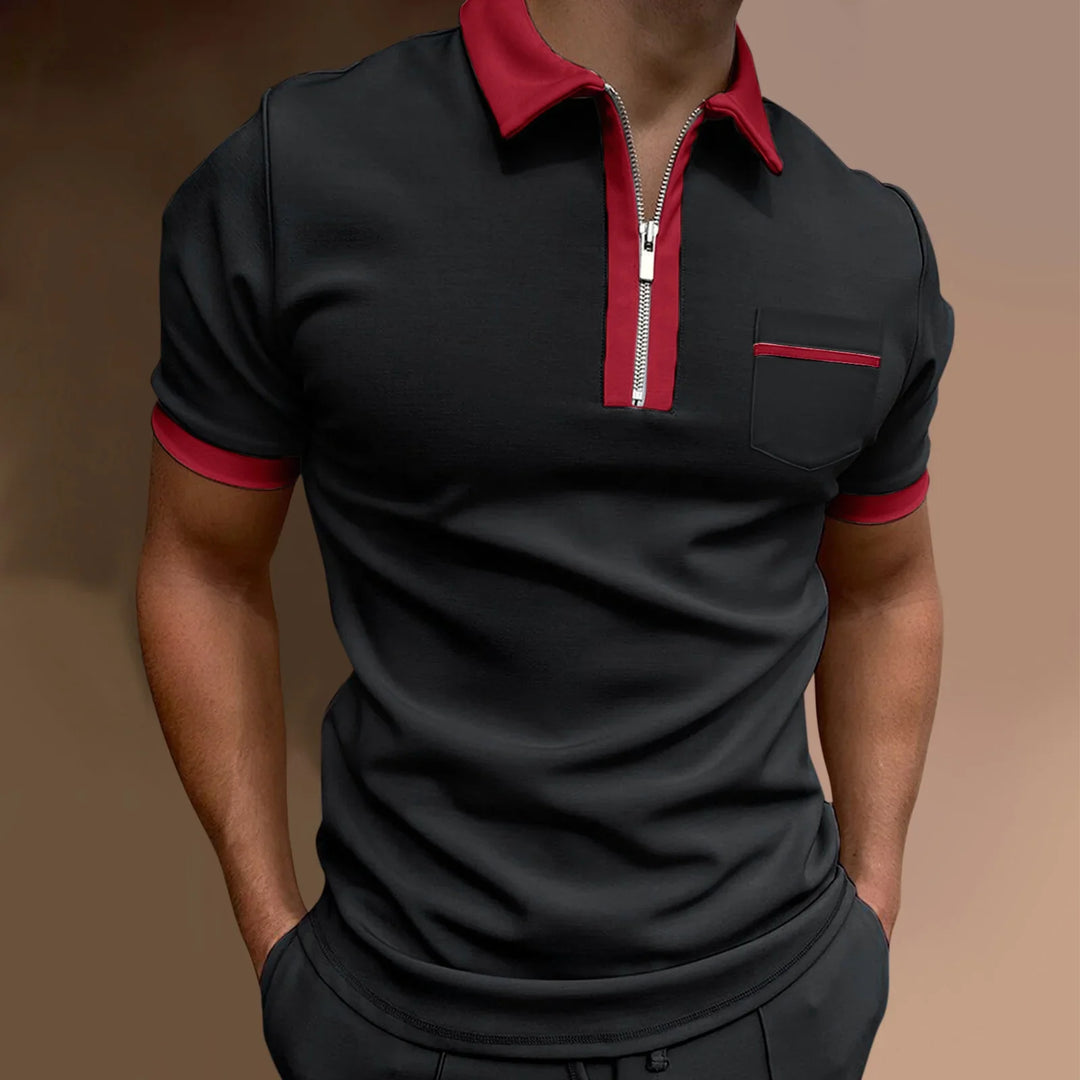 Black short sleeve polo shirt with red collar, zipper, sleeve edges, and chest pocket detail