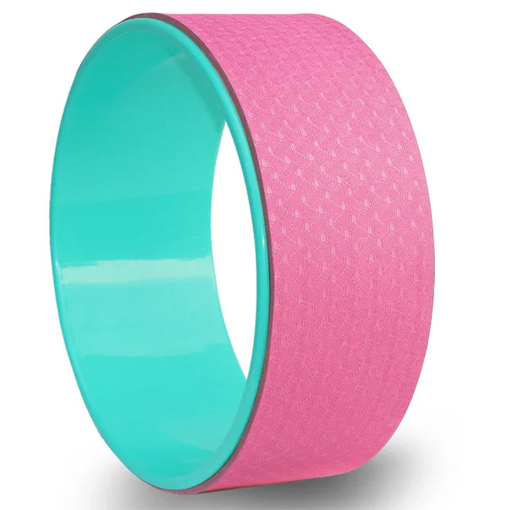 Pink and teal yoga wheel with textured surface for stretching and balance exercises