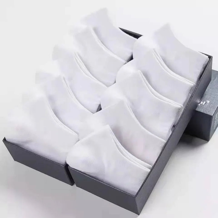 Box of neatly folded white ankle socks arranged in two rows on a white background