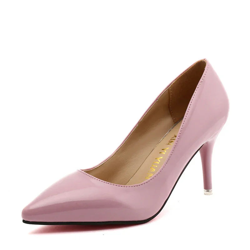 Glossy pink high heel pointed toe women's pump shoe on white background