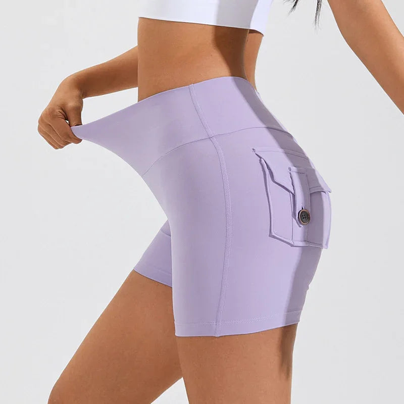 Woman stretching waistband of light purple high-waisted stretch shorts with side button pocket