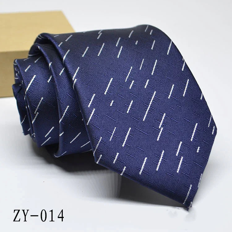 Navy blue necktie with white diagonal dash pattern, folded on white surface, code ZY-014