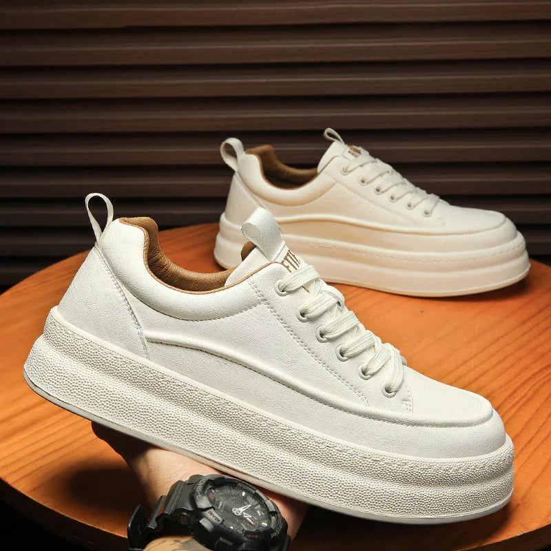 White platform sneakers with beige lining on wooden table, casual fashion shoes