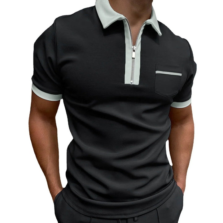 Men's black polo shirt with light grey collar, zipper, pocket trim, and sleeve edges