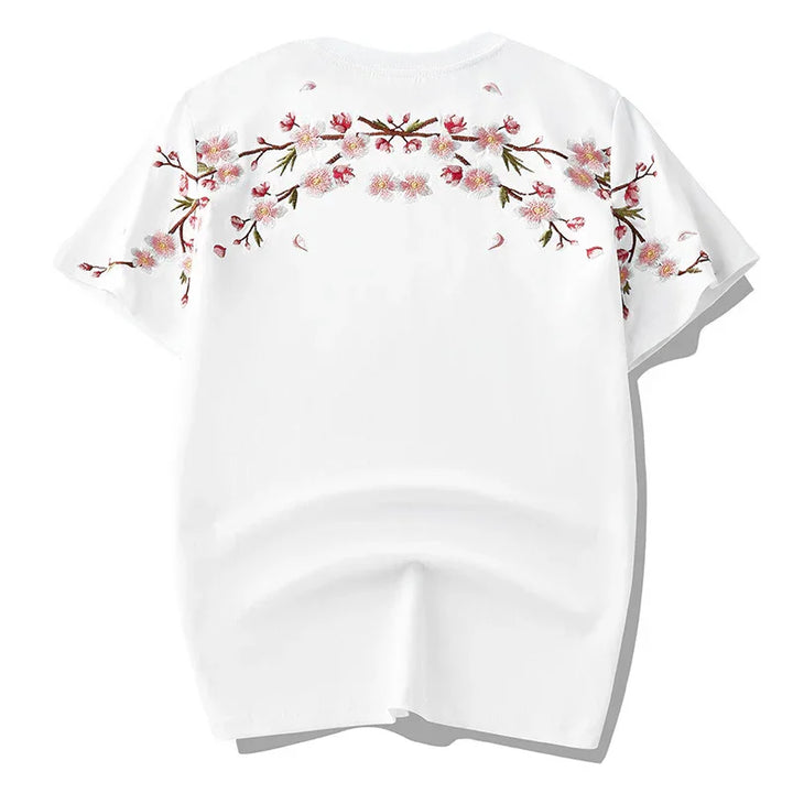 White short-sleeve t-shirt with pink cherry blossom embroidery across shoulders and sleeves