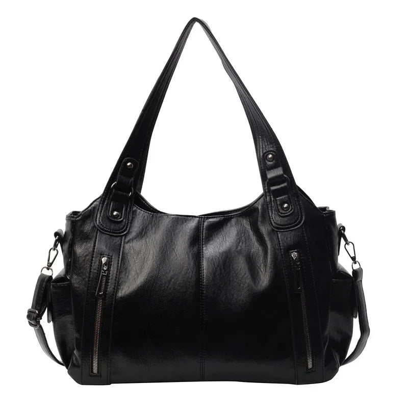 Black leather handbag with dual handles, front zipper pockets, and detachable shoulder strap