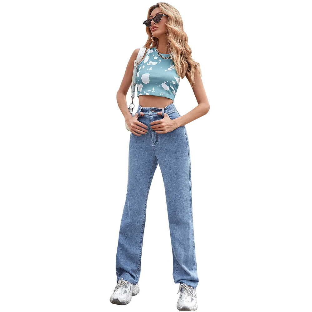 Woman wearing blue tie-dye crop top with high-waist straight jeans and white sneakers