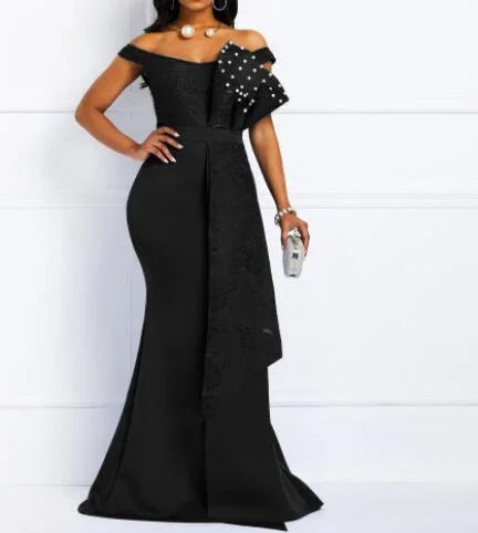 Elegant black off-shoulder evening gown with pearl-embellished bow detail and floor-length design