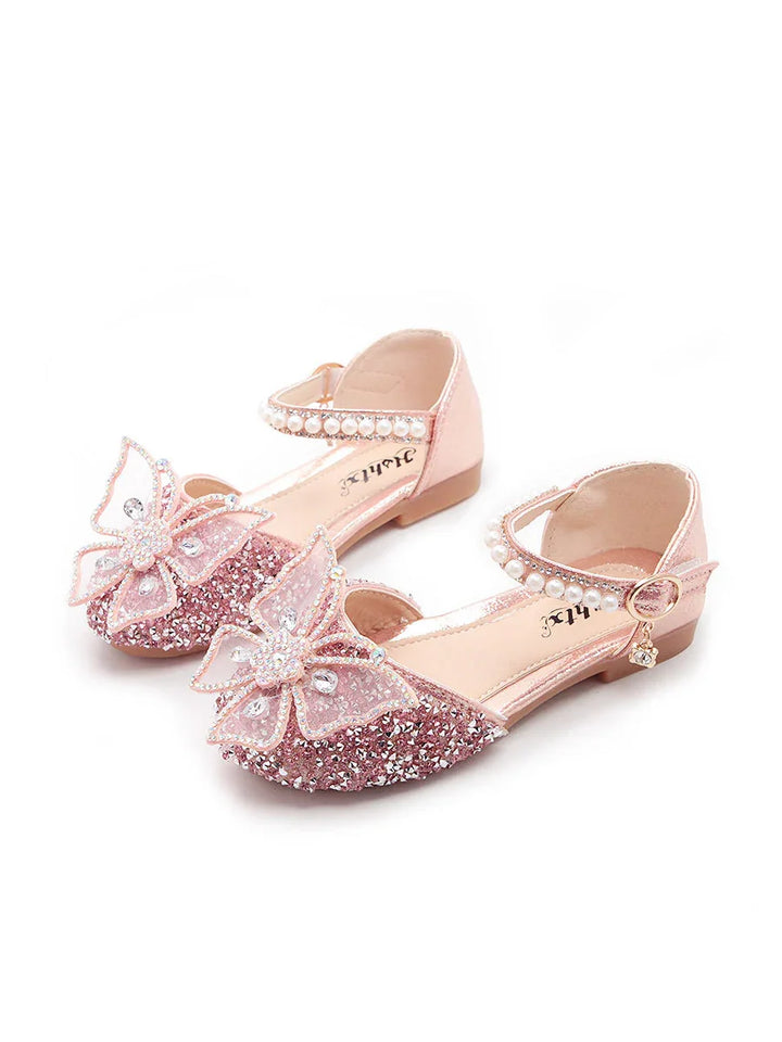 Pink glittery girls' shoes with butterfly decorations, pearl ankle straps, and small heels