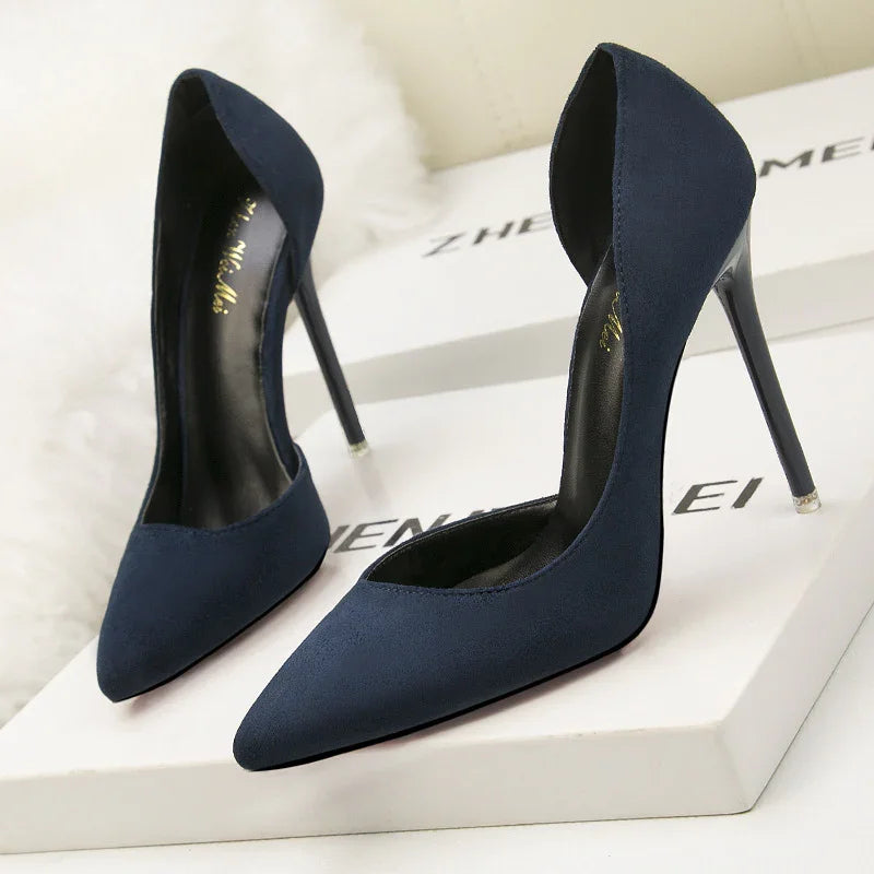 Elegant navy blue suede high heel pumps with pointed toes on white branded boxes