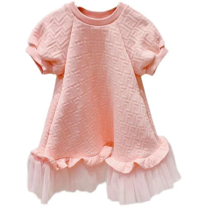 Soft pink baby dress with quilted texture, short sleeves, and ruffled tulle hem