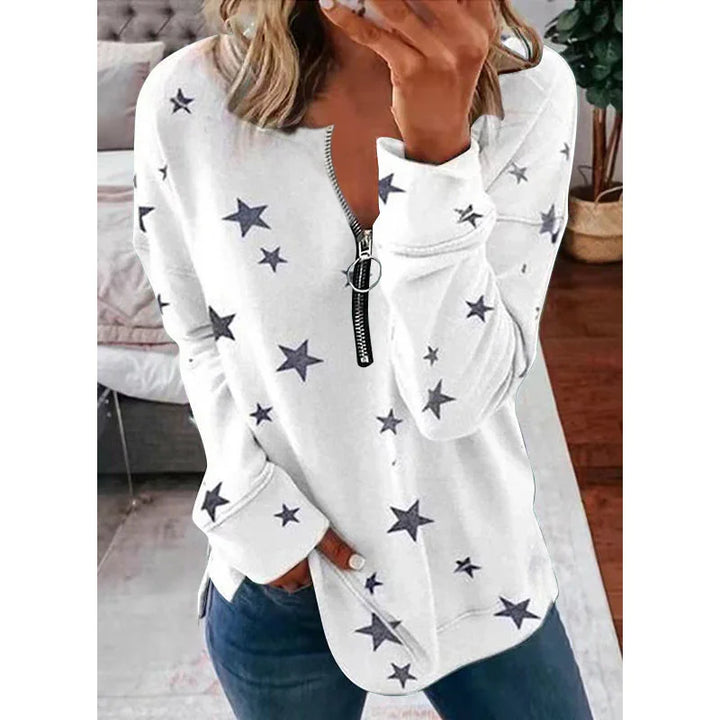 White star print pullover with half zipper and ring pull, worn with blue jeans indoors