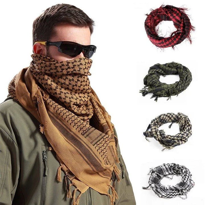 Man wearing brown tactical shemagh scarf and sunglasses with four additional folded shemagh scarves in red, green, beige, and black colors