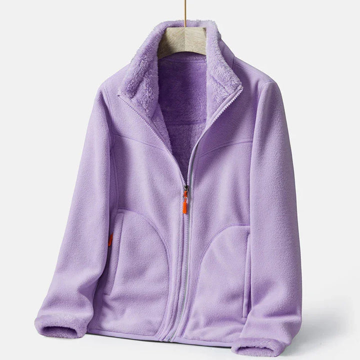 Light purple fleece jacket with full zip and high collar on wooden hanger