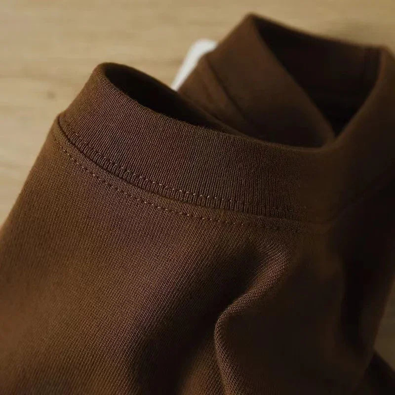 Close-up of brown fabric seamless sock on wooden surface, soft knit texture