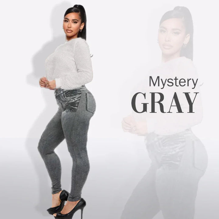 Woman modeling gray high-waisted leggings with textured white sweater and black heels against white backdrop