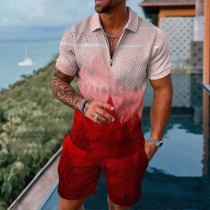 Man in red and beige patterned short-sleeve shirt and matching shorts by pool with ocean view