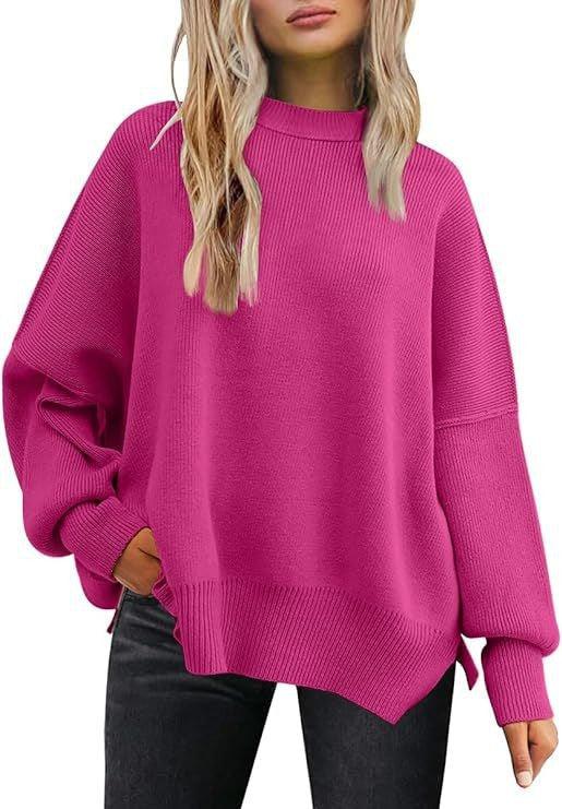 woman wearing oversized hot pink knitted sweater with long sleeves and black pants