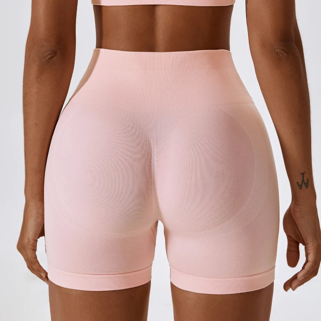 Back view of woman in seamless high-waisted pink biker shorts, activewear apparel