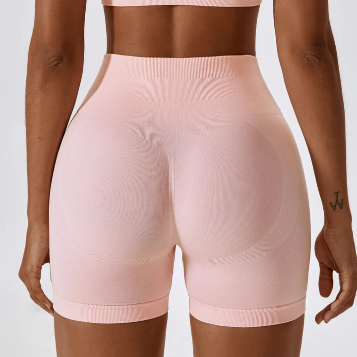 Back view of woman in seamless high-waisted pink biker shorts, activewear apparel
