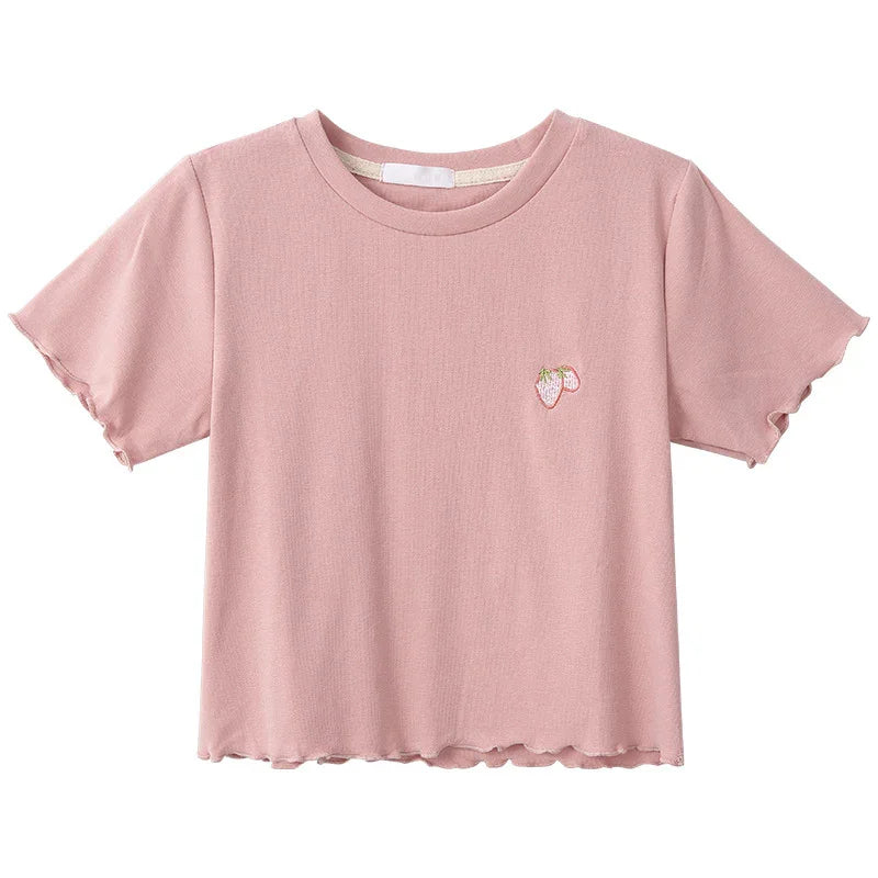 Pink short-sleeve women's crop top with small embroidered strawberry on chest and lettuce-edge sleeves