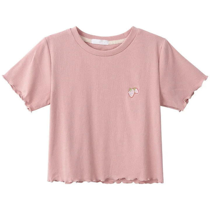 Pink short-sleeve women's crop top with small embroidered strawberry on chest and lettuce-edge sleeves
