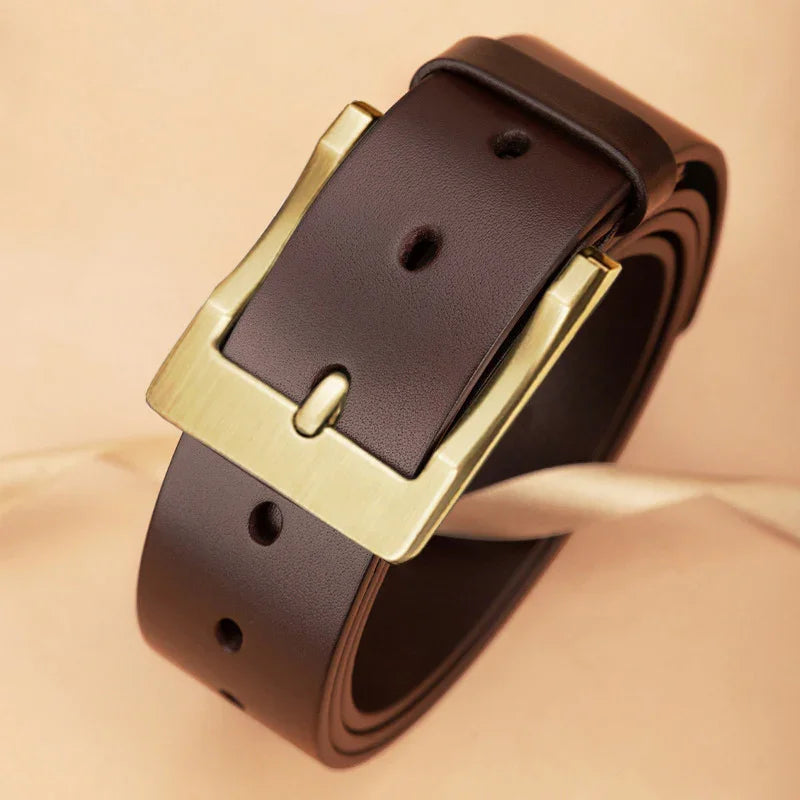 Classic dark brown leather belt with gold metal buckle on beige background