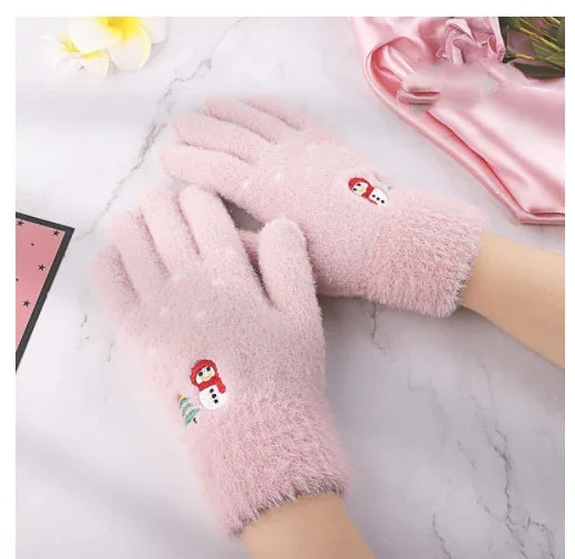 Soft pink fuzzy gloves with embroidered snowman design on a marble surface
