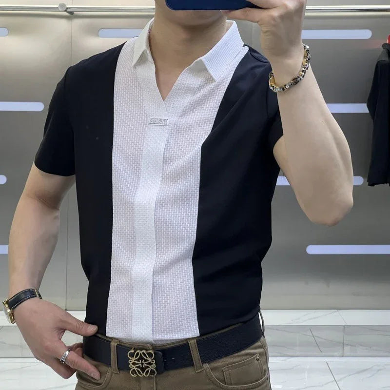 Man wearing black and white short-sleeve shirt with geometric pattern and black belt with gold buckle