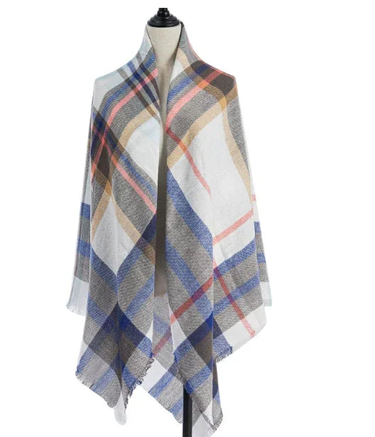 Soft plaid shawl in blue, beige, white, and orange draped on mannequin