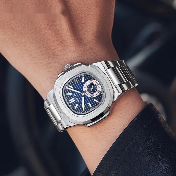 Silver stainless steel wristwatch with blue dial and subdial on wrist