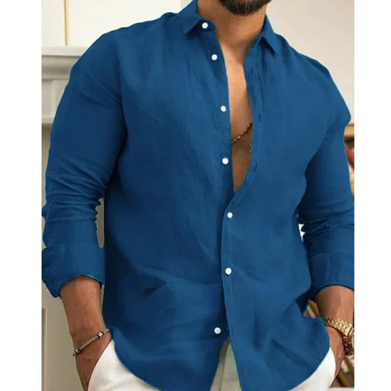 Man wearing stylish blue long-sleeve button-up shirt with white buttons and white pants