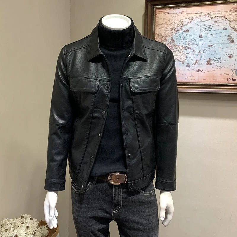Mannequin wearing black leather jacket over black turtleneck and dark jeans with belt