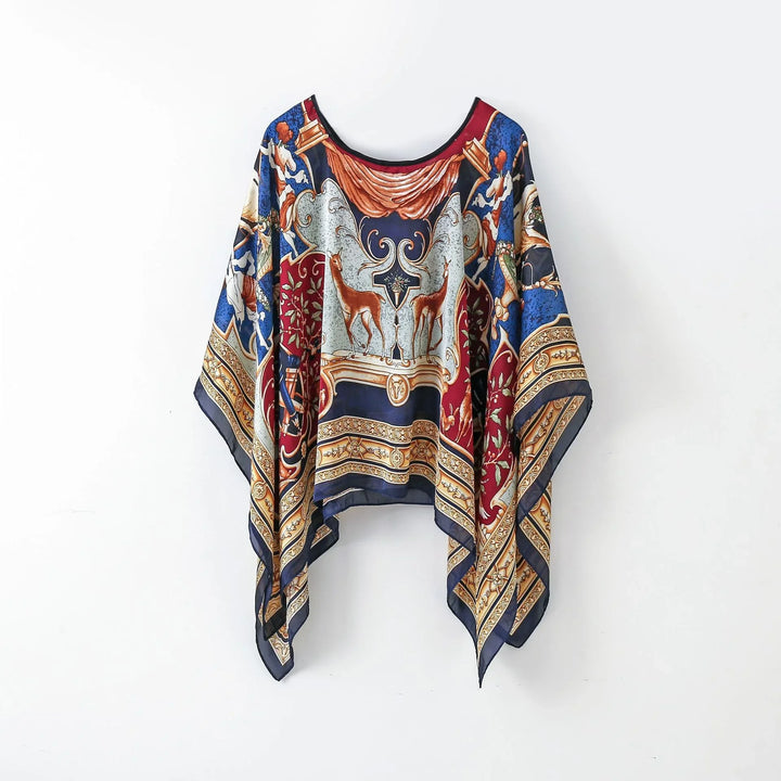 Flowy silk poncho with intricate baroque print featuring deer, cherubs, and ornate patterns in blue, red, and gold