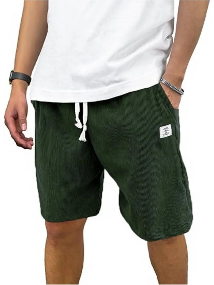 Casual men's olive green shorts with white drawstring, worn with a white t-shirt