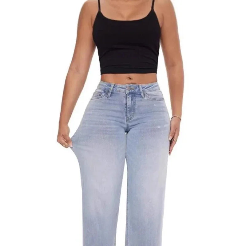 Woman wearing light blue high-waisted stretchy wide-leg jeans and a black cropped tank top